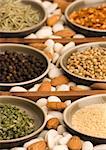 Dried Chives and various spices close up in a wooden tray.