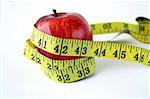 Isolated Apple with measuring tape around in white background