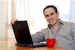 Man sitting at a desk and looking into his computer