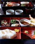 Japanese bento set with rice and raw fish. Shallow DOF. Focus on the rice.