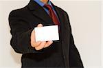 business man holding a white card (focus on the card)