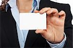 Business woman holding one blank card over a white background. Focus at front