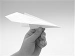 child's hand with paper plane