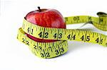 Apple with measuring tape around in white background