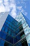 Glass facade of business skyscraper with reflections