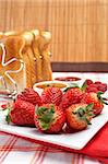 Strawberries, raspberries, slices of bread and jam for healthy breakfast. Shallow DOF