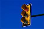 Red traffic light on blue sky. Stop sign