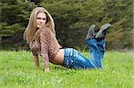 cheerful girl laying on the green grass.