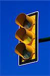 Yellow traffic light on blue sky