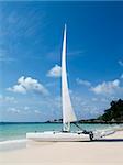 Catamaran sailboat on a white, tropical beach on a sunny day at Koh Samet in Rayong province, Thailand