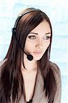The girl the operator in headphones with a microphone