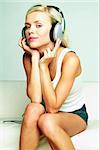 Young beautiful happy women listening music in headphones