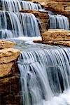 Beautiful cascading waterfall over natural rocks, landscaping element