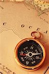 Antique brass compass over old USA map background