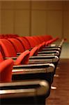 A line of red theatre chairs - short depth of field.