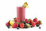 A glass of berry smoothie surrounded by fresh fruits