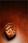 Whiskey in light pool on brown table with copyspace