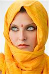 attactive and strong eyes behind an orange scarf used like a burka