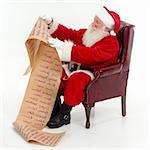 Santa Claus seated in a chair checking his list of boys and girls, white background, square