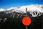 Red sign with ski slopes in background.