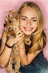 Caucasian young adult female with Yorkshire Terrier dog.