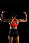 Back view of muscular African American woman with biceps flexed.