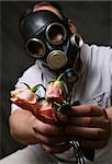The man in a gas mask with flowers