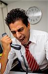 angry businessman screaming on the phone