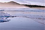 the waves are gently coming in on the tropical sandy beach