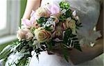 Wedding hands on a bridal bouquet