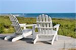 Adirondack chairs on deck looking towards beach on Bald Head Island, North Carolina.