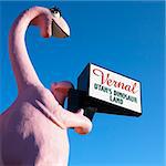 Pink dinosaur holding sign for city of Vernal, Utah.