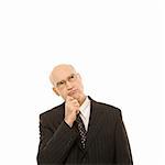 Caucasian middle-aged businessman looking thoughtful standing against white background.