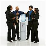 Multi-ethnic business group of men and women standing at water cooler conversing.