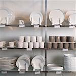 Retail display of porcelain dishes and mugs.