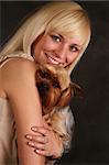 The girl holds the puppy of the yorkshire terrier