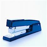 Blue stapler on white background.