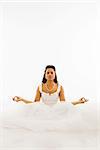 Mid-adult African-American bride mediating with white background.