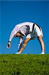 healthy lifestyle: man doing stretching in a park