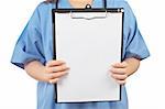 Friendly female doctor in blue scrubs, showing a blank clipboard, over a white background.