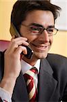friendly businessman talking on the phone and smiling