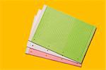 Colored blank notebooks over yellow