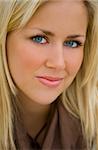 Close up portrait of a beautiful young blond woman with stunning blue eyes