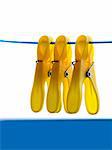 Three clothes yellow clip on blue rope.