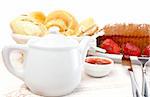 Fork, knife, strawberries, raspberries, slices of bread, sugar cubes and jam for healthy breakfast. Shallow DOF