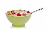 Cornflakes of fruits with the spoon inside the green bowl, reflected on white background. Shallow DOF