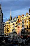 Paris street with colorful houses at sunset. France.