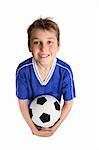 A young boy in soccer uniform ready to play soccer.