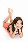 Eight year old female child laying on white background smiling wearing casual clothes