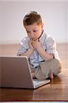 Child concentrated on a computer at home